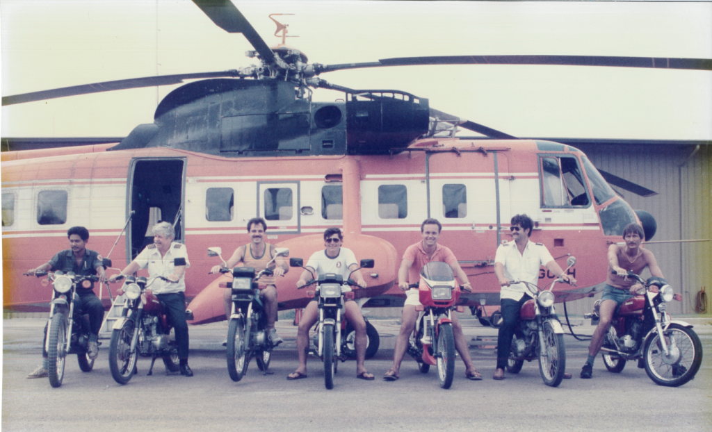 Maxcraft President Daryl MacIntosh (Third) While in Thailand in Front of the Same Helicopter Circa 1983