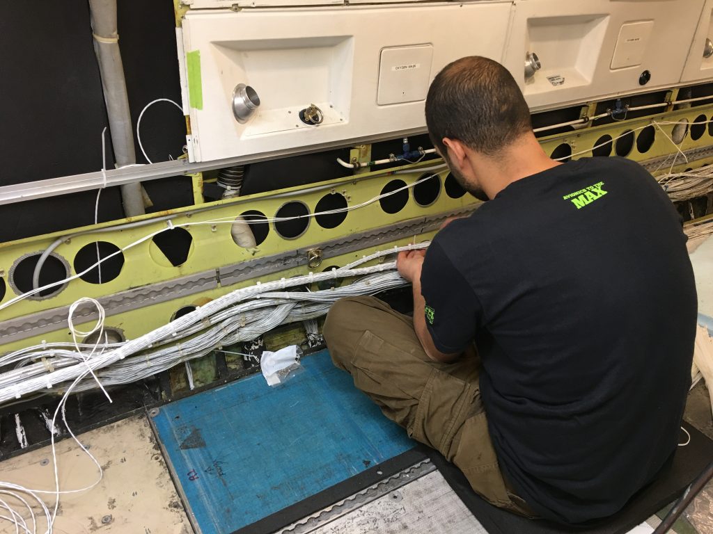 A Maxcraft Technician Running Wires Throughout the Aircraft