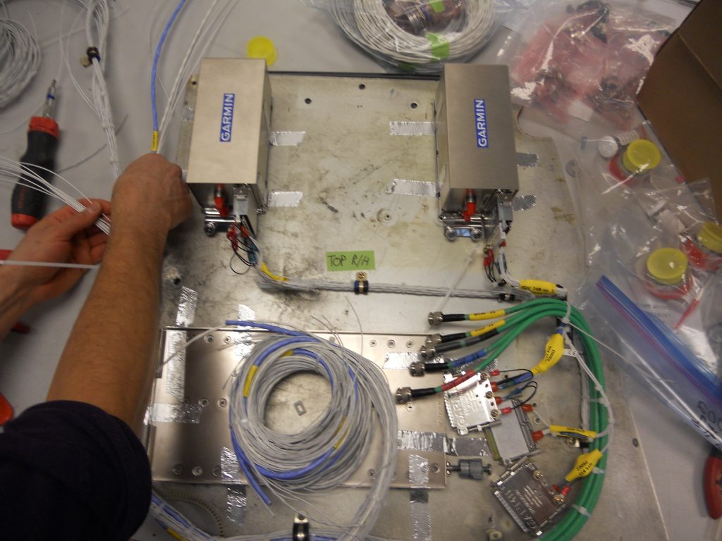 A Maxcraft Technician Prefabricates Wiring Harnesses on a Bench Outside the Aircraft