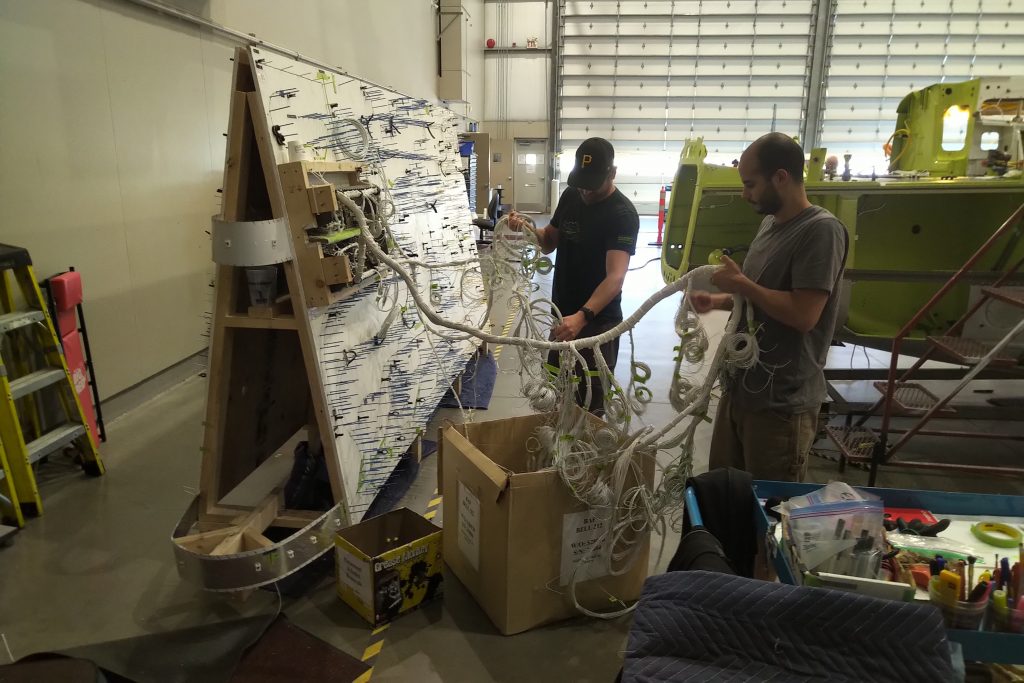 Maxcraft Technicians Remove the Completed Wiring from the Board to Install in the Helicopter