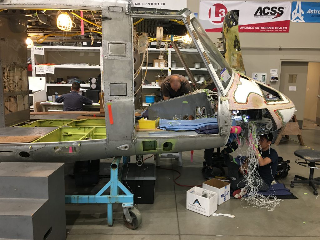 Multiple Maxcraft Technicians Completing Various Tasks on One of the Gutted Bell 212s