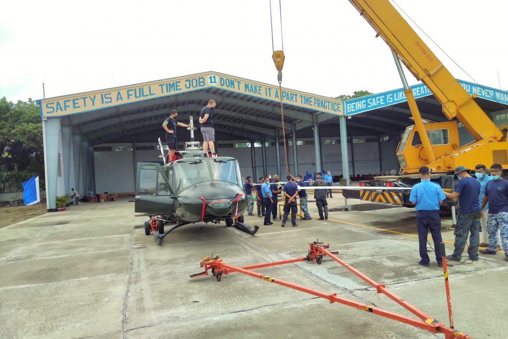 One of the Helicopters Having the Rotor Blades Installed Using a Crane