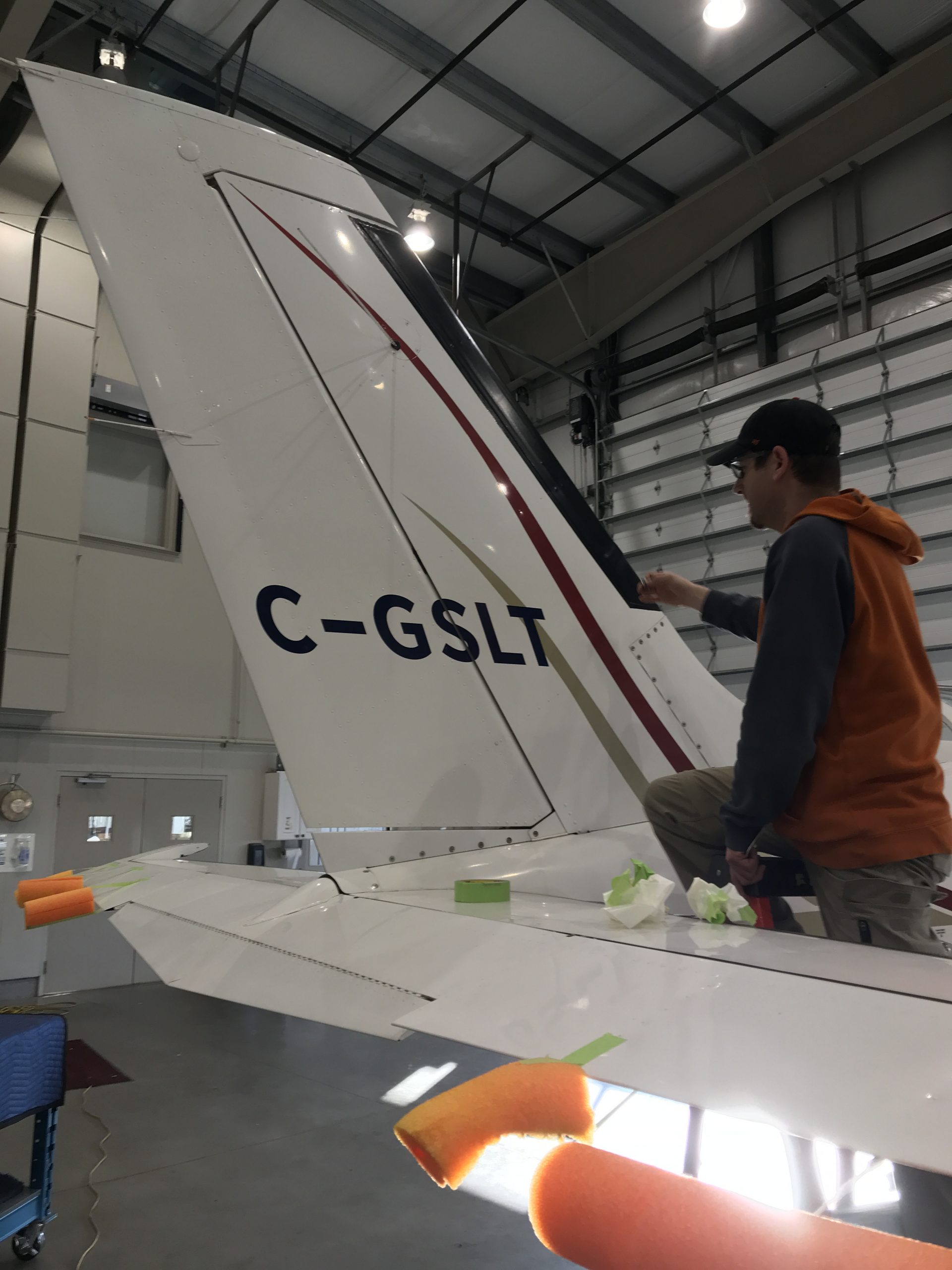 A Maxcraft Technician Installs the New Canadian Registration on the Tail