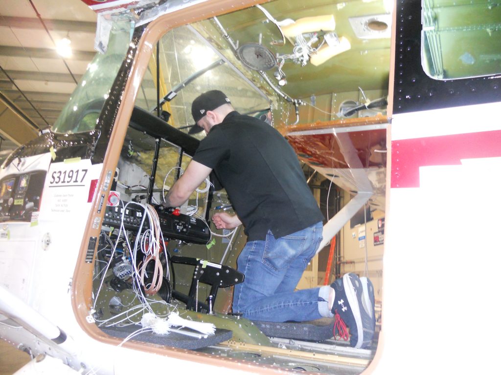 A Maxcraft Technician Runs Wires for Various Systems