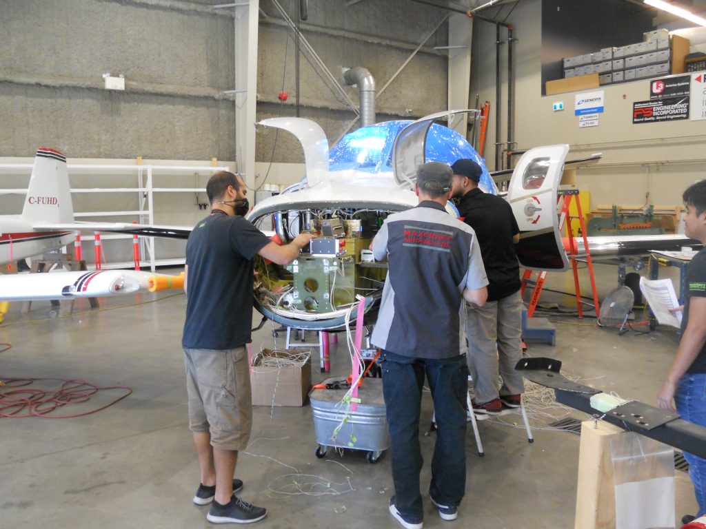 Maxcraft Technicians Installing New Equipment in the Nose Avionics Bay