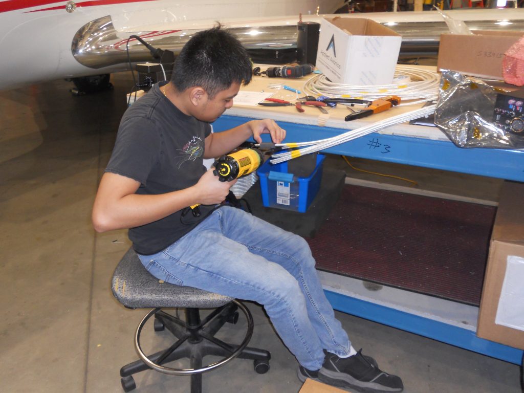 A Maxcraft Technician Building a Wiring Bundle of Coax