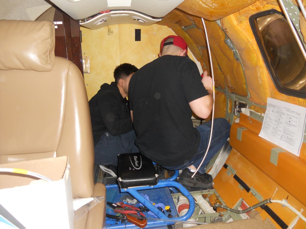 Maxcraft Technicians Working in the Rear of the Cabin