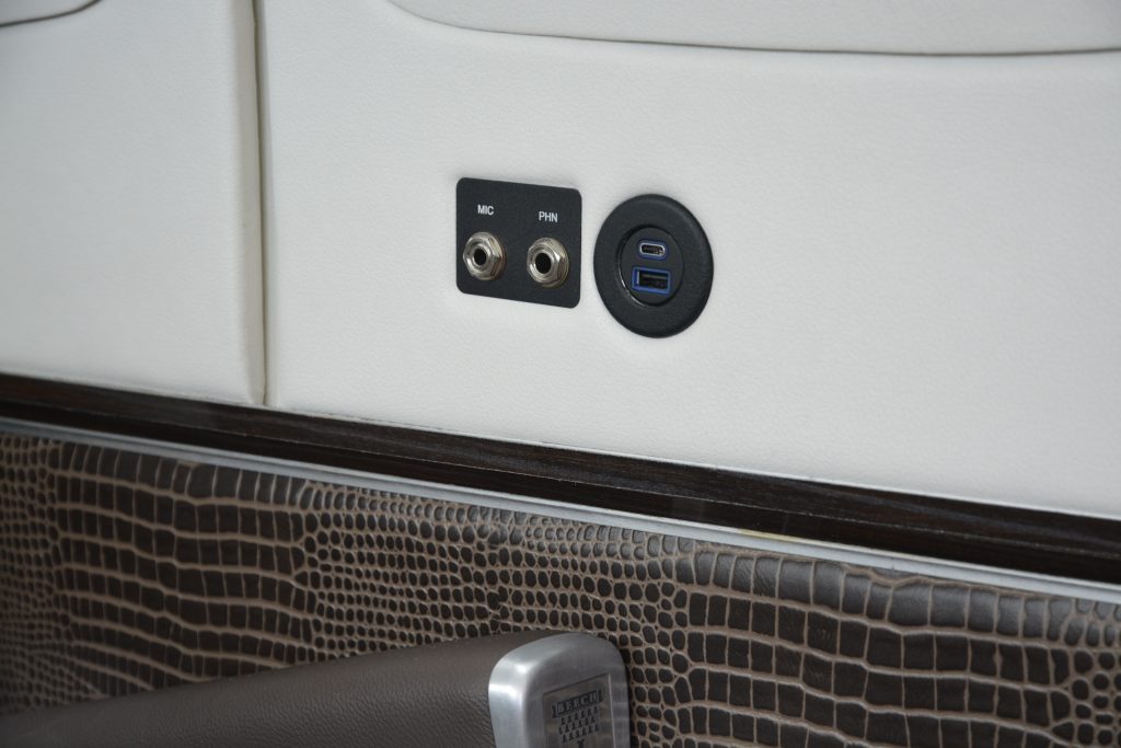 One Pair of Headset Jacks and Charging Ports Located Next to One of the Passenger Seats