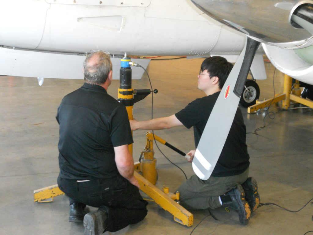 Maxcraft Technicians Jacking the King Air Up Using Specialized Scales to Weigh the Entire Aircraft