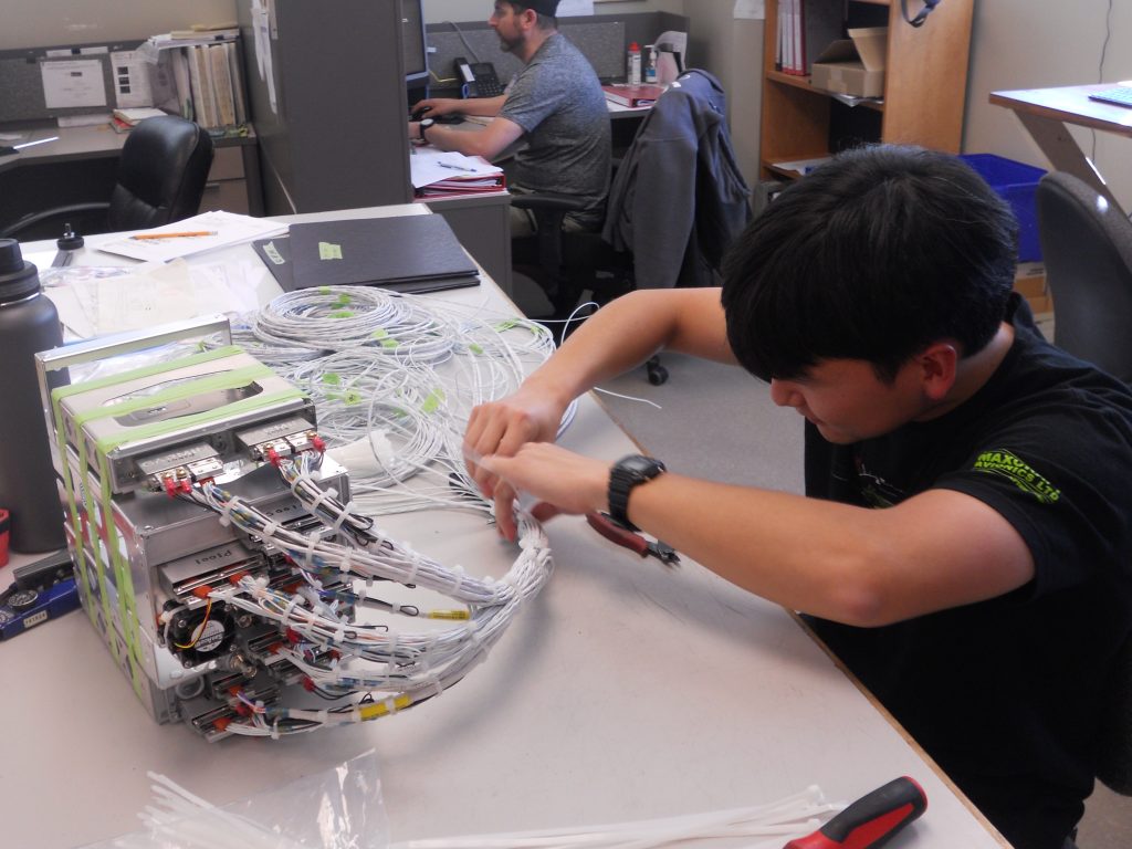 A Maxcraft Technician Working on the Radio Stack Wiring Harness