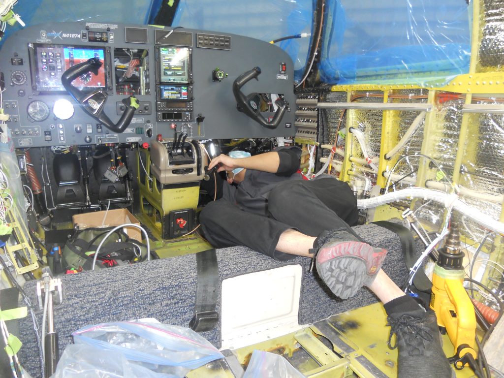 A Maxcraft Technician Working Under the Panel During the Equipment Configuration Stage