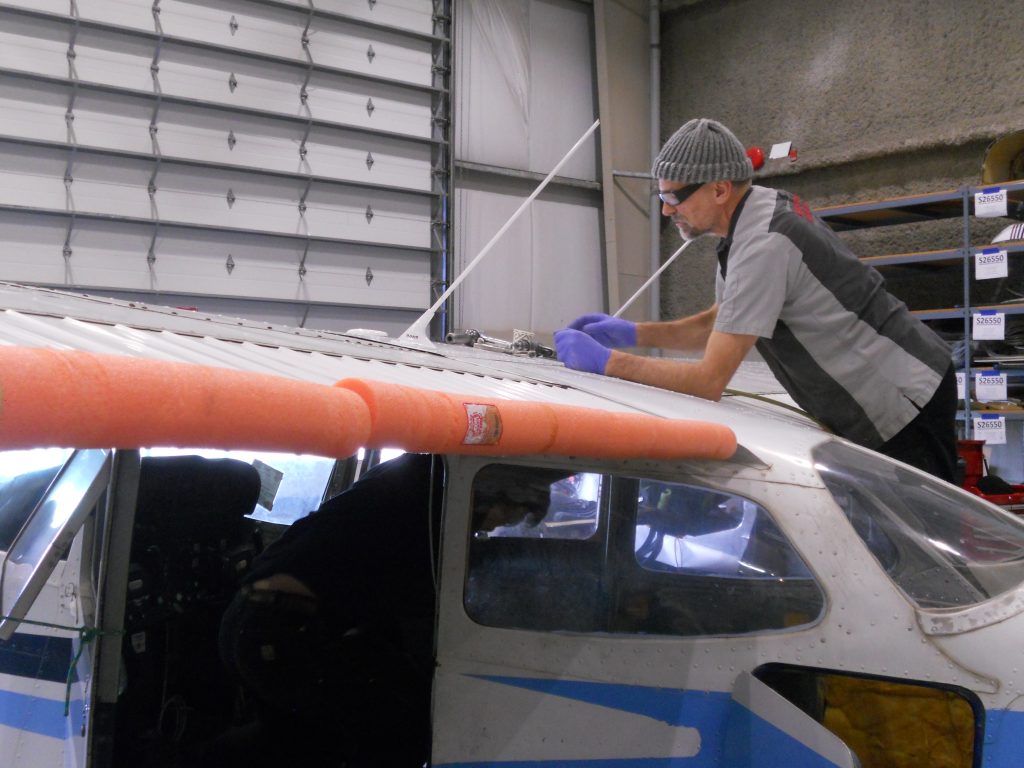Maxcraft Technician Installing a New Antenna on the Roof of the Aircraft