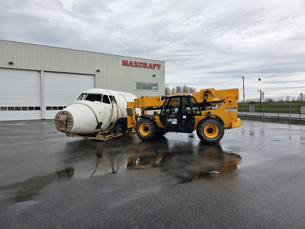 Roughly ¼ of a Dash 7 Fuselage Being Unloaded on Maxcraft’s Door Step