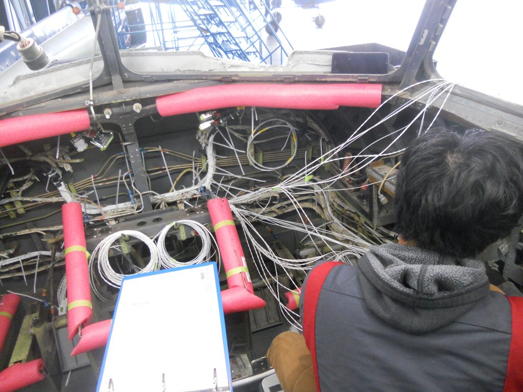 A Maxcraft Technician Routing Wiring Around the Flight Deck